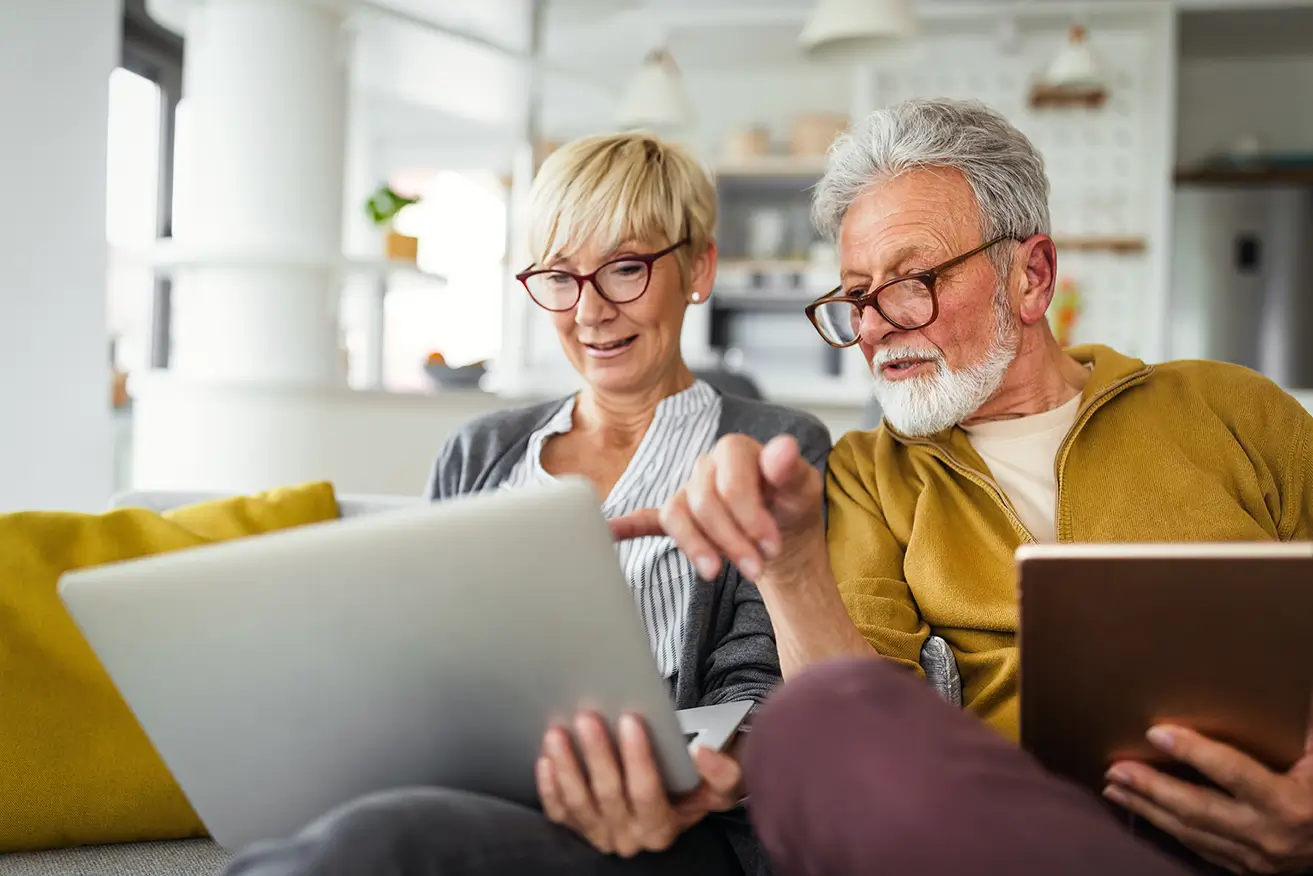 2025 Tax Law Changes Retiree couple reviewing 2025 tax deductions and charitable giving options.