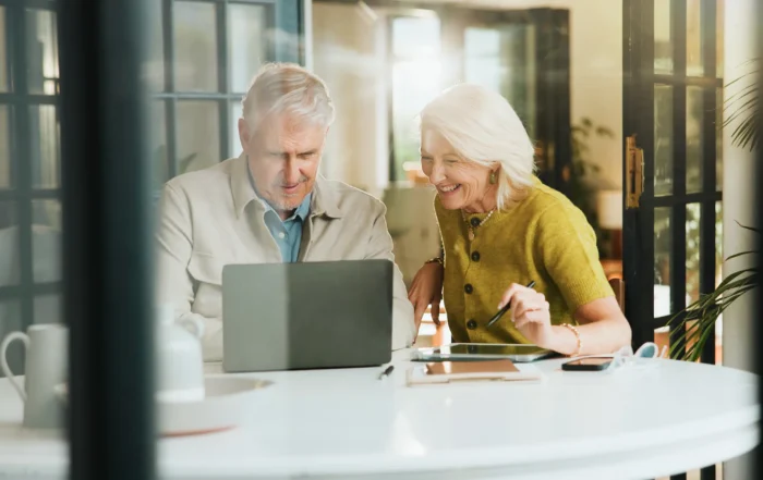 Financial advisor meeting with a couple to discuss proactive financial planning for their retirement strategy.