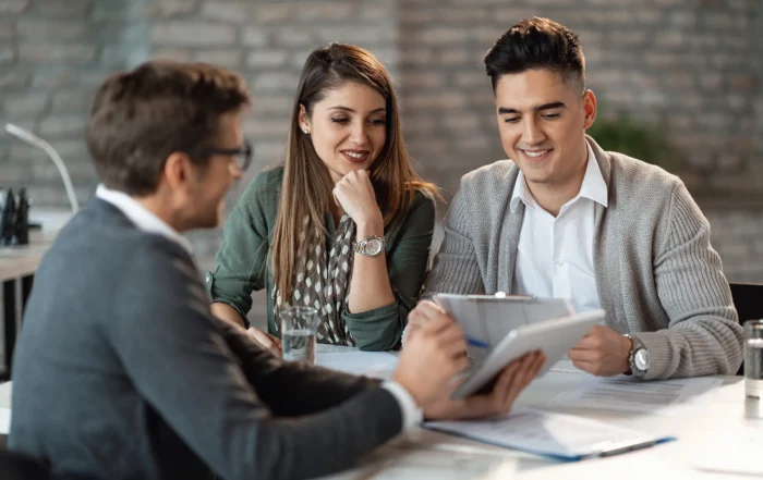 A professional financial advisor meeting with a high-net-worth client to evaluate investment strategies.